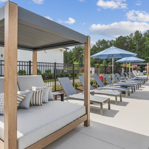 cabanas next to pool with tanning deck
