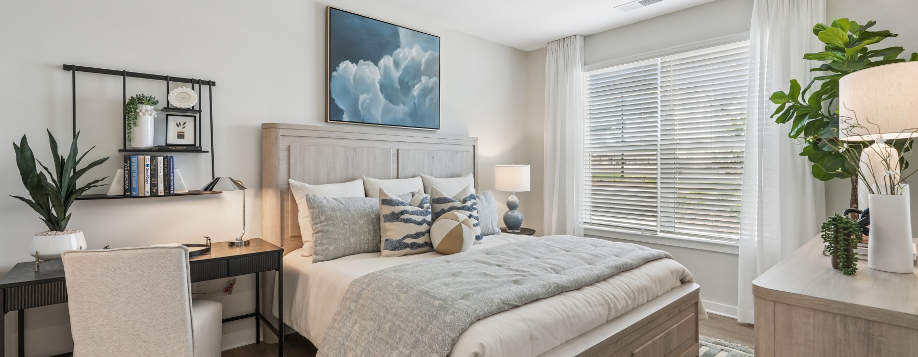 A bedroom with a large bed in a 2 bedroom apartment in Durham, NC